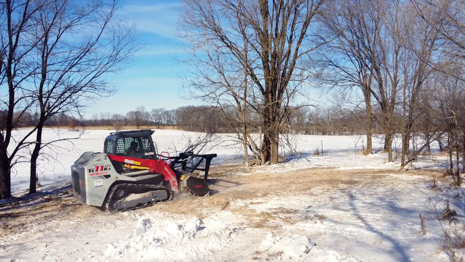 Kingdom Service Takeuchi mulcher clearing land on a Wisconsin property